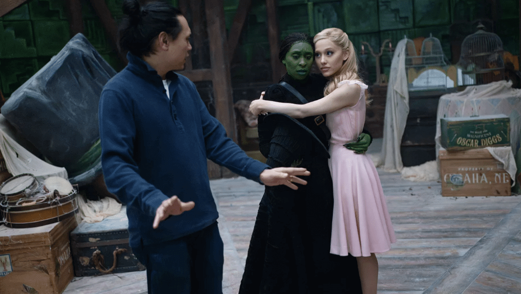 Jon M. Chu, Cynthia Erivo and Ariana Grande on the set of Wicked. Photo: Giles Keyte/Universal Pictures